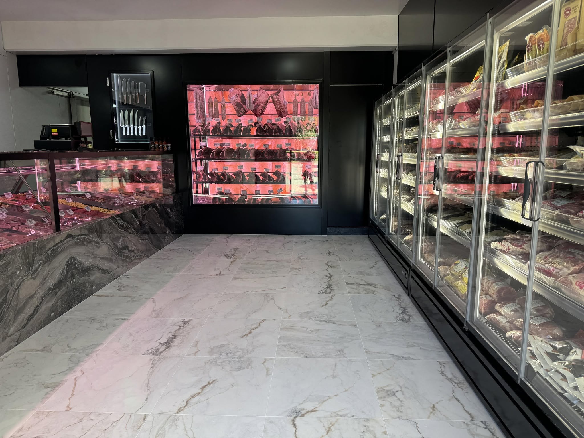 Inside Brads Butchery, the display cases and marble floor